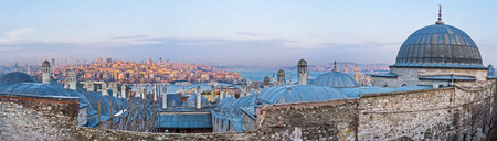 The grey domes of the Suleymaniye Burial Complex with the view on the Beyoglu district inthe sunset beams, Istanbul, Turkey.のeditorial素材