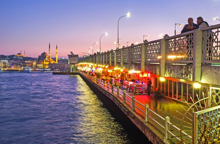 ISTANBUL, TURKEY - JANUARY 21, 2015: The bright lights on the ground level of Galata bridge attracts people to the fine fish restaurants and cozy cafes, located there, on January 21 in Istanbul.のeditorial素材
