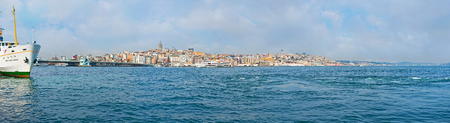 The blue waters of the Golden Horn Bay with the Beyoglu district on the background, Istanbul, Turkey.の写真素材