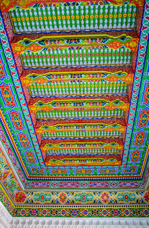 KOKAND, UZBEKISTAN - MAY 6, 2015: The  ceiling in the Khudayar Khan Palace decorated with the wooden carvings and colorful arabesques, on May 6 in Kokand.のeditorial素材