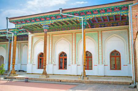KOKAND, UZBEKISTAN - MAY 6, 2015: The courtyard of Khudayar Khan Palace with the shady arcades, decorated ceilings, carved wooden pillars and ornaments on the plaster walls, on May 6 in Kokand.のeditorial素材