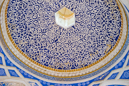 KOKAND, UZBEKISTAN - MAY 6, 2015: The blue cupola of the entrance gate of of Khudayar Khan Palace, covered by fine white patterns, on May 6 in Kokand.のeditorial素材
