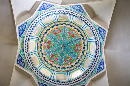 KOKAND, UZBEKISTAN - MAY 6, 2015: The cupola of the Norbut-biy Mosque has form of octagonal star and decorated with the frescos, depicting the colorful floral ornamentation, on May 6 in Kokand.のeditorial素材