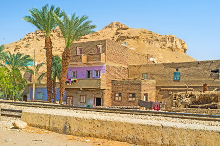 The urban street of Al Kilabiyyah with the unfinished residential houses, located along the railroad, Upper Egypt.のeditorial素材