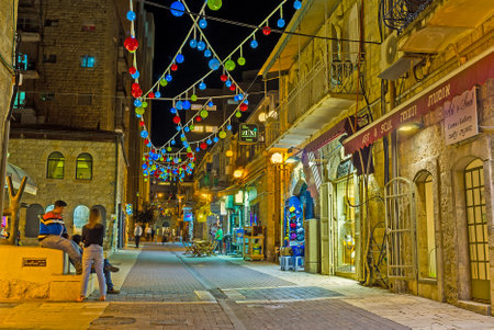 JERUSALEM, ISRAEL - FEBRUARY 17, 2016: The narrow street, decorated with the beautiful colorful lanterns, is full of art galleries and workshops, on February 17 in Jerusalem.のeditorial素材