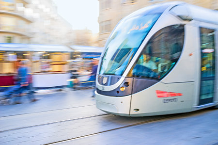 JERUSALEM, ISRAEL - FEBRUARY 18, 2016: The tram in motion,  riding along the Yafo Road, on February 18 in Jerusalem.のeditorial素材