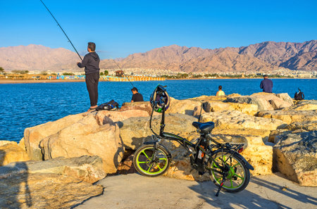 EILAT, ISRAEL - FEBRUARY 24, 2016: The fishermen enjoy the mountain landscapes and amazing nature...