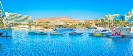EILAT, ISRAEL - FEBRUARY 23, 2016: Panorama of marina with a lot of tiny colorfull tourist boats, on February 23 in Eilat.のeditorial素材