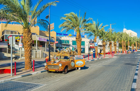 EILAT, ISRAEL - FEBRUARY 24, 2016: The tourist car decorated with the model of the medieval town-fortress and colorful reliefs, on February 24 in Eilat.のeditorial素材