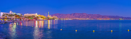The luxury resort looks great in twilight with the red mountains of Aqaba on the background, Eilat,...