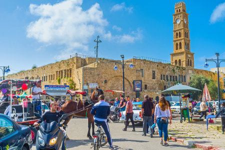 ACRE, ISRAEL - FEBRUARY 20, 2016: The clock tower of Khan al-Umdan (Inn of Columns) rises over the medieval Akko and is the largest and best preserved khan in Israel, on February 20 in Acre.のeditorial素材