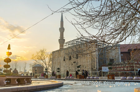 ANKARA, TURKEY - JANUARY 16, 2015: The scenic winter sunset over the Haci Bayram Square with the beautiful frozen pond, ancient Temple wall and high minaret, on January 16 in Ankara.のeditorial素材