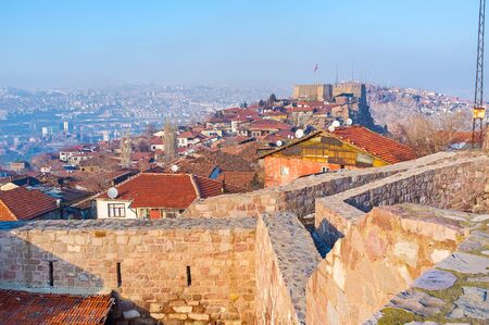 The red tiled roofs of the old houses between the buildings of the medieval Hisar Citadel, Ankara, Turkey.の写真素材