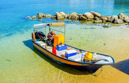 CAESARIA, ISRAEL - MAY 19, 2016: The fisherman in his boat, on shore of the old harbor, on May 19 in Caesaria.のeditorial素材
