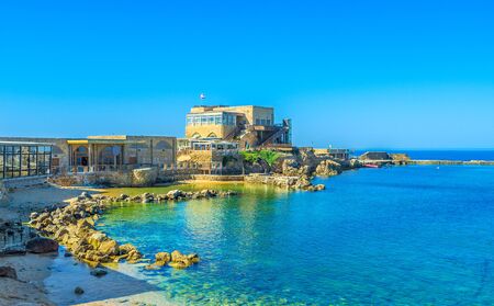 The scenic harbor surrounded by the cozy cafes and luxury restaurant, offering fine local cuisine, Caesaria, Israel.の写真素材