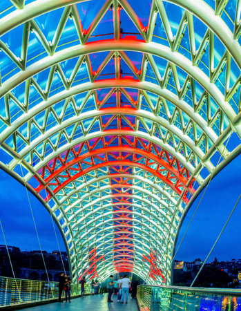 TBILISI, GEORGIA - MAY 28, 2016: The glass tent of the Peace Bridge illuminated in colors of National Flag of Georgia, on May 28 in Tbilisi.のeditorial素材