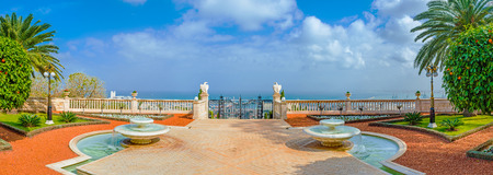 The scenicterrace in the middle Bahai Gardens decorated with the symmetric fountains, flower beds and marble eagles on the hendrails, Haifa, Israel.の写真素材