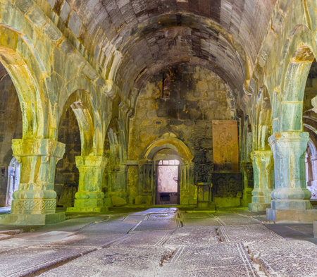 SANAHIN, ARMENIA - MAY 30, 2016: The interior of Sanahin Monastery with the row of arched passes and medieval tombstones, covering floor, on May 30 in Sanahin.のeditorial素材