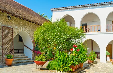 The beautiful garden with flowers in pots in St Minas Monastery, Vavla, Cyprus.の写真素材