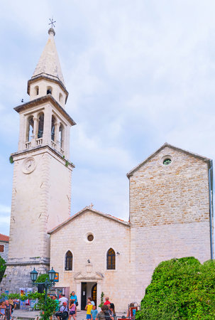 BUDVA, MONTENEGRO - JULY 15, 2014: The facade of the medieval St Ivan's Cathedral with the slender bell tower, located in the old town - citadel, on July 15 in Budva.のeditorial素材
