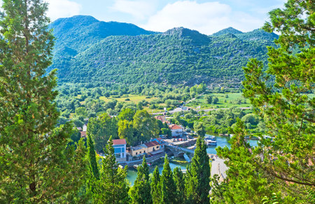 The aerial view on the roofs of Virpazar through the trees of the Castle hill, Montenegro.のeditorial素材
