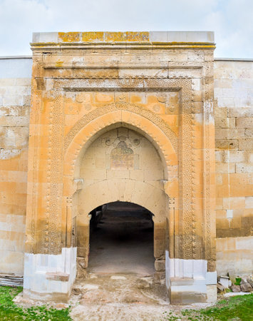The gate of Agzikarahan Caravan Saray, built of bright orange local stone and decorated with carved patterns, Cappadocia, Turkey.のeditorial素材