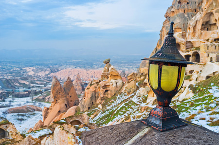 The old style lantern with the ruins of housing of Byzantine period on the background, Uchisar, Cappadocia, Turkey.の写真素材