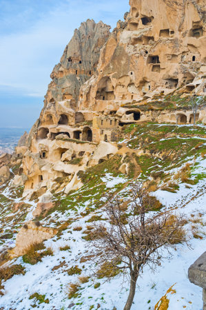 The slope of the ancient rock with the numerous chambers, carved in it, that are the parts of the Citadel, occupying this rock, Uchisar, Cappadocia, Turkey.のeditorial素材