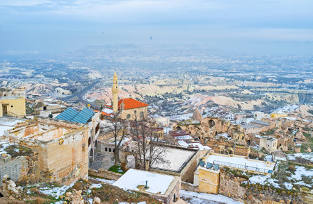 The view from the Uchisar Castle on the town roofs on the hill in foggy winter day, Cappadocia, Turkey.のeditorial素材
