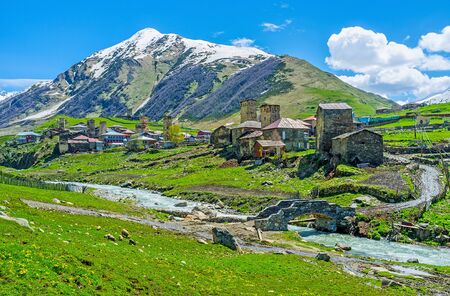 The medieval houses and towers of Ushguli on the bank of Enguri river in the same named gorge in Svaneti, Georgia.の写真素材