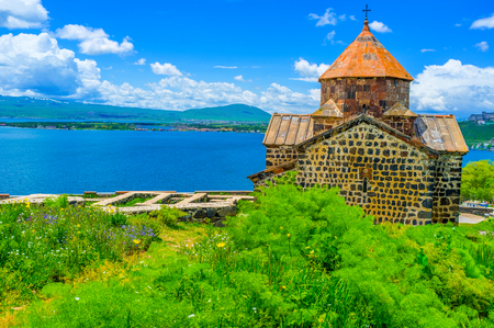 The Sevanavank Monastery surrounded by lush greenery of Sevan Peninsula, Armenia.の写真素材