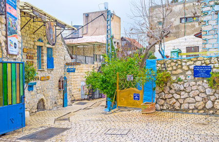 SAFED, ISRAEL - FEBRUARY 22, 2016: The tiny square at the entrance to the Galley Street with numerous Hebrew sign boards, on February 22 in Safed.のeditorial素材