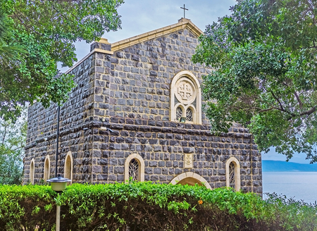 The Church of the Primacy of St Peter located in shady garden on the bank of Kinneret Lake, also...