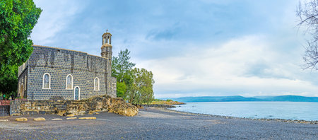 The tiny harbor at the site of the Church of the Primacy of St Peter and the black pebble beach, Tabgha, Isael.のeditorial素材