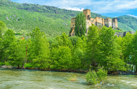 The old Khertvisi fortress is washed by mountain river Kura, Samtskhe-Javakheti Region, Georgia.のeditorial素材