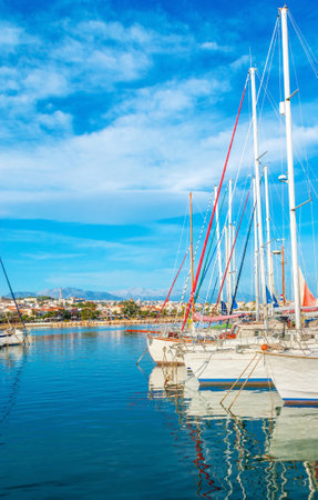 The bright blue waters of the Aegan Sea reflect the white yachts, moored in the new port, Rethymno, Crete, Greece.のeditorial素材