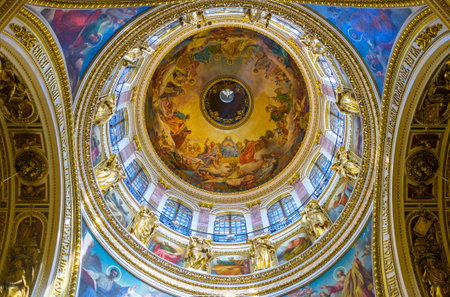 SAINT PETERSBURG, RUSSIA - APRIL 25, 2015: The great dome of St Isaac's Cathedral with the Holy Spirit in the middle, surrounded by painted icons, and sculptures of Saints, on April 25 in Saint Petersburg.のeditorial素材
