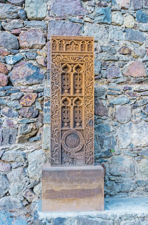 The old khachkar with fine patterns at the wall of Geghard Monastery, Kotayk Province, Armenia.のeditorial素材