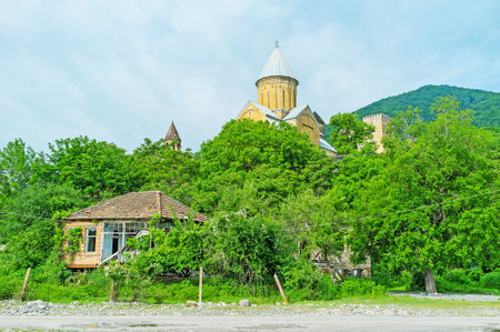 The dome of Assumption Church of Ananuri fortress rises from the lush greenery, seen from the bank of Aragvi River, Mtskheta-Mtianeti Region, Georgia.のeditorial素材