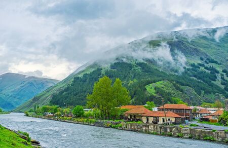 The mountain foggy village of Sno, located in gorge  by Snostskali river, Georgia.