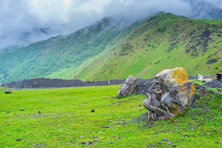 The unusual landmark of the mountain village Sno - the stone heads of four most known historic...