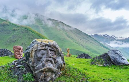 The monumental stone heads of the famous poets and writers in misty gorge of Sno, Georgia.