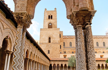 The view on bell tower of Monreale Cathedral through the scenic arch with richly decorated columns, with fine carved patterns and mosaic inlay, Sicily, Italy.のeditorial素材
