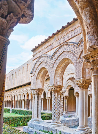 The old garden of Monreale Cloister surrounded by the scenic arcade with unique columns, decorated in different technics, Sicily, Italy.のeditorial素材