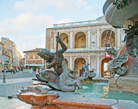 LORETO, ITALY - OCTOBER 6, 2012: The great fountain in Madonna Square decorated with bronze tritons, dolphins, winged serpents and coats of arms, on October 6 in Loreto.のeditorial素材