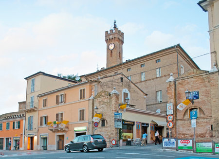 LORETO, ITALY - OCTOBER 6, 2012: The walk outside the city wall with the view on shops, stalls, cafes and the old clock tower, rising above the houses, on October 6 in Loreto.のeditorial素材