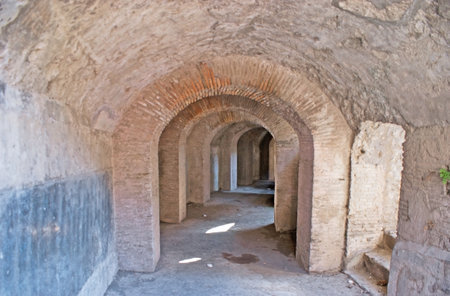 The inner narrow corridor under the huge building of Amphitheater, Pompeii, Italy.のeditorial素材