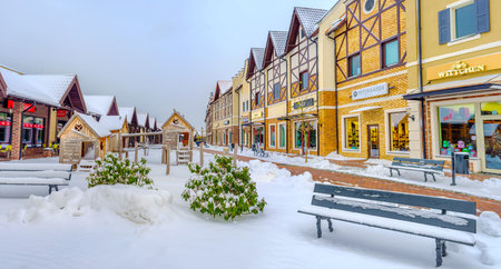 KIEV, UKRAINE - NOVEMBER 11, 2016: The gambrel-roofed houses of the Dutch shopping neighborhood with the snowy benches on the foreground, on November 11 in Kiev.のeditorial素材
