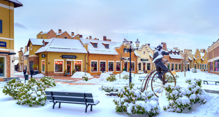 KIEV, UKRAINE - NOVEMBER 11, 2016: The winter in Dutch Revival style shopping city with roofs, park, benches and streets, covered with fluffy snow, on November 11 in Kiev.のeditorial素材