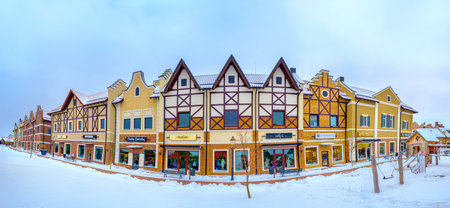 KIEV, UKRAINE - NOVEMBER 11, 2016: The stepped gable houses in Dutch Revival style shopping neighborhood occupied with the fashion boutiques and surrounded by snowy streets, on November 11 in Kiev.のeditorial素材